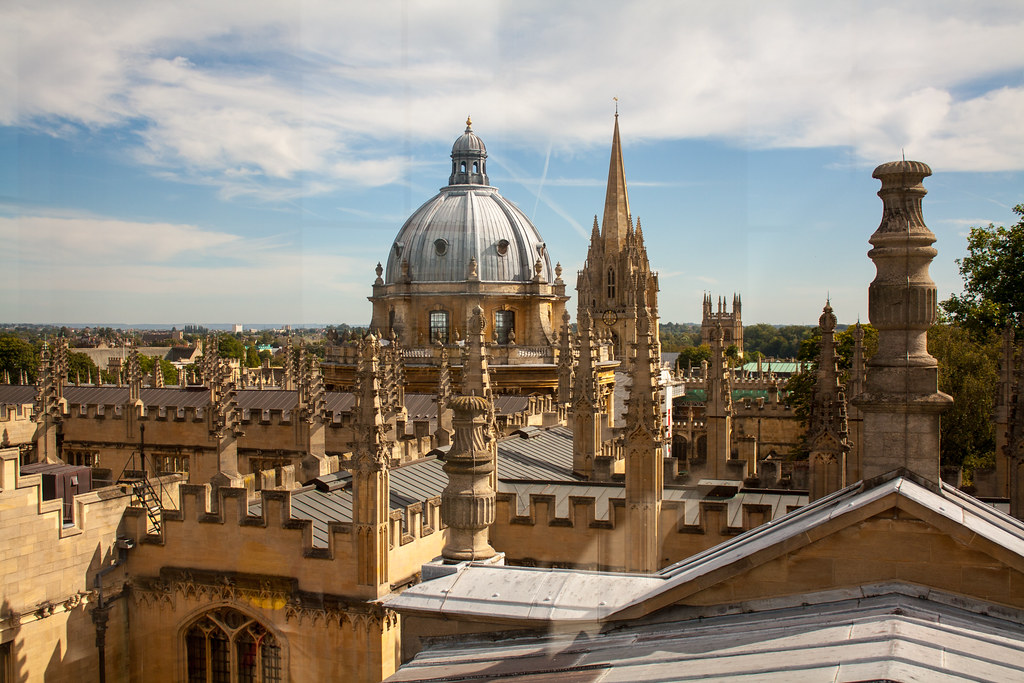 A photo of Oxford city's skyline, layered over with Urban Trails' trademark polka dot branding 